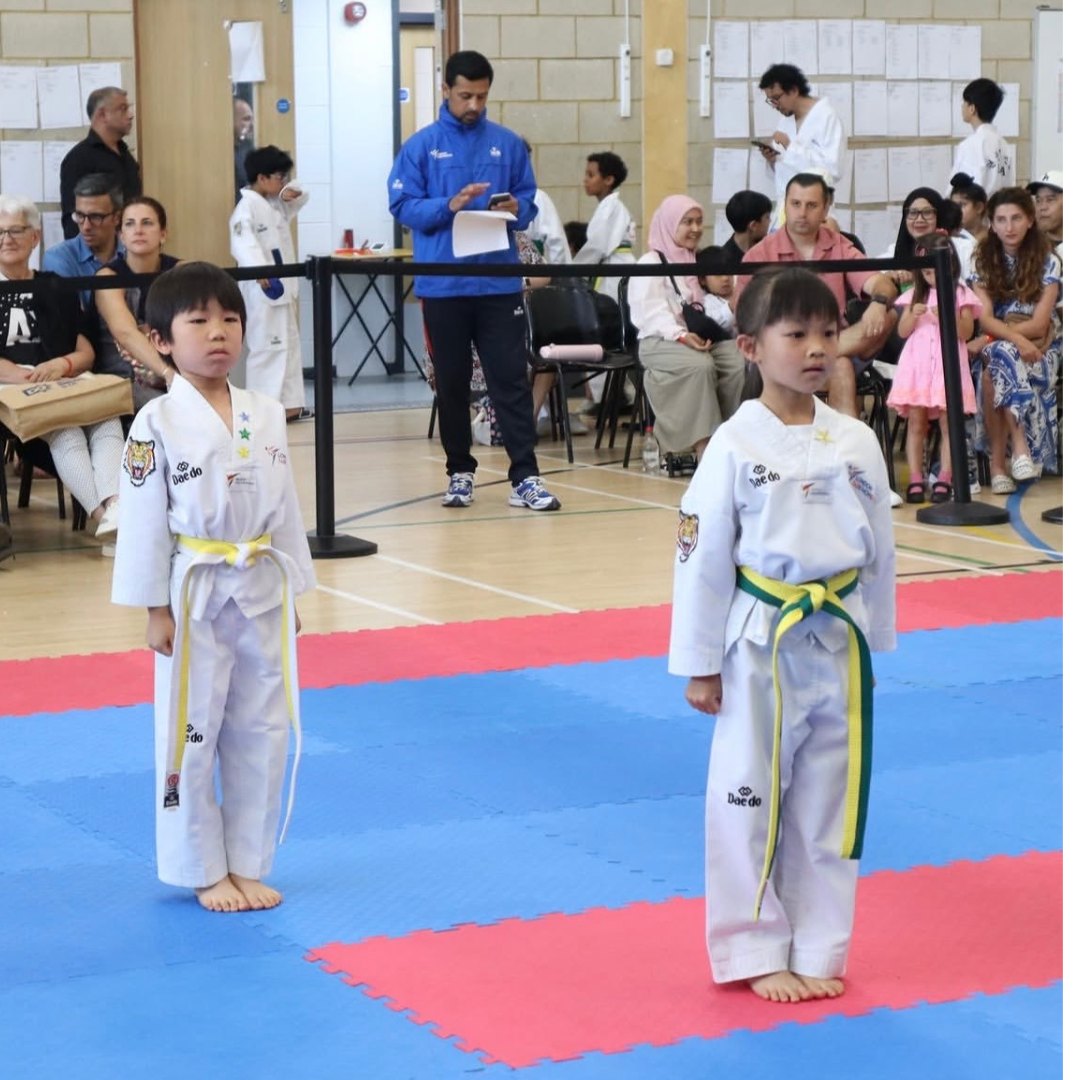 Young Little Panthers students lined up in uniform at a grading