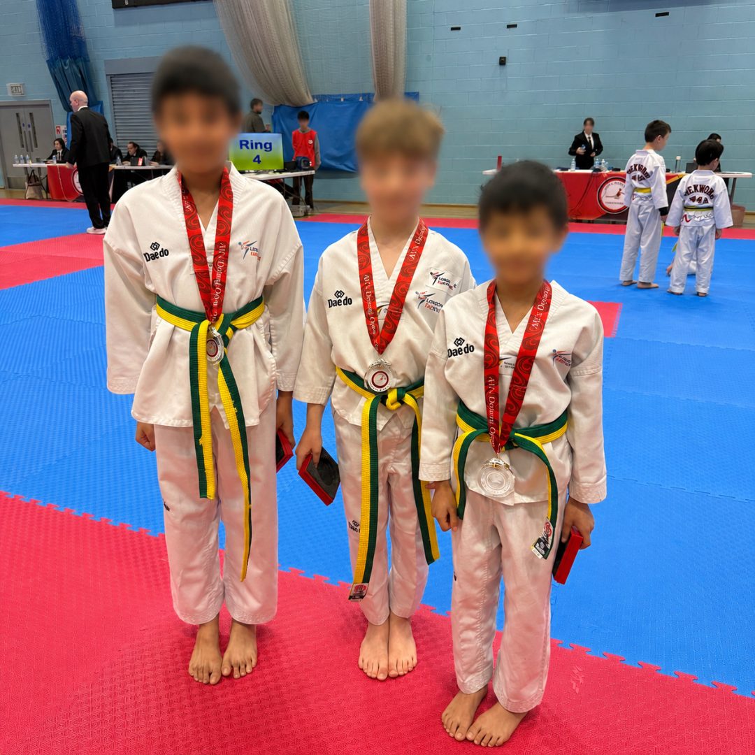 Three students with medals at the AKA Dojang Open